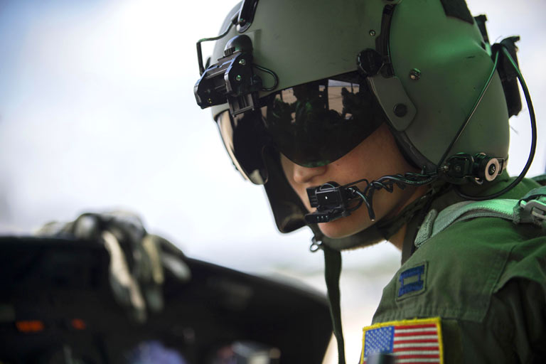 A pilot in the cockpit of a plane prepares for flight.